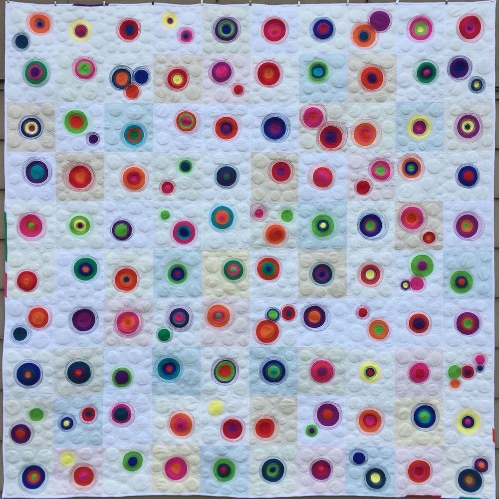 Description: Resonance uses colorful quilting thread to create a sense of outward movement and reverberation from central points.  Threads that coordinate with each fabric create a blending sensation as the quilting merges the appliquéd circles with each other and the background.  This quilt was my first 100-day project, from New Year's Day 2018 to my birthday, which fell on the 100th day of the year.