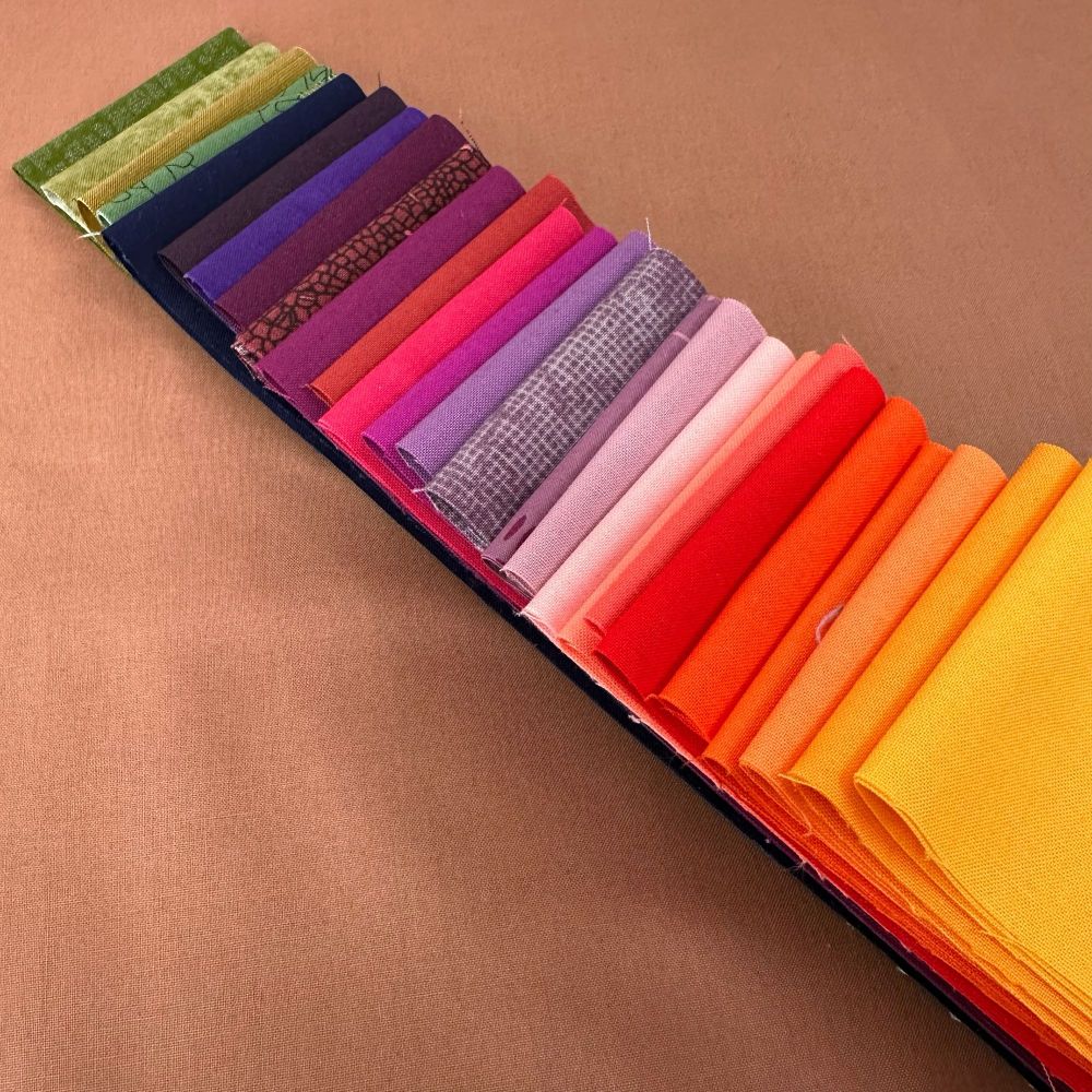 Fabric pull for the Pantone Quilt Challenge featuring Ruby + Bee Field Mouse and strips of a fabric in a rainbow of color