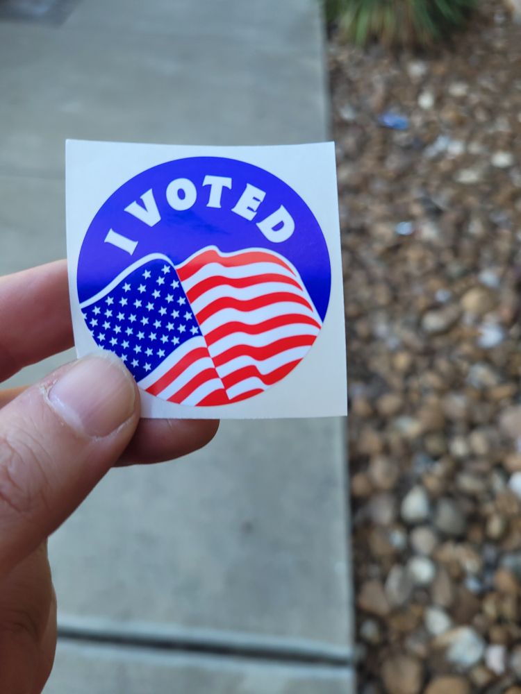 Picture of my I Voted sticker with waving American flag