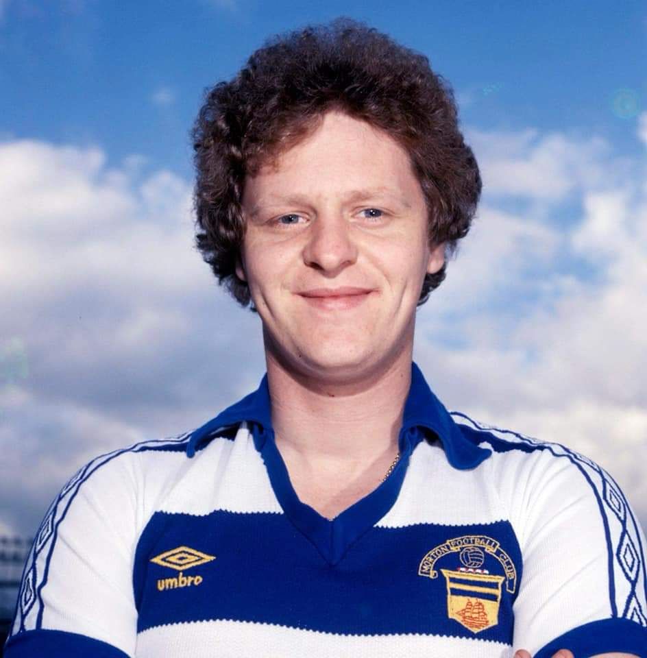 Portrait photo on Andy in his blue and white hoops Morton football shirt, with a cloudy blue sky behind him.