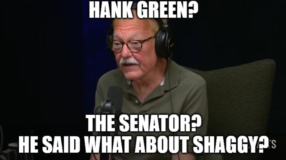 It shows an older man wearing glasses and headphones, speaking into a microphone in what appears to be a podcast or radio studio.

Top text:
"HANK GREEN?"

Bottom text:
"THE SENATOR? HE SAID WHAT ABOUT SHAGGY?"