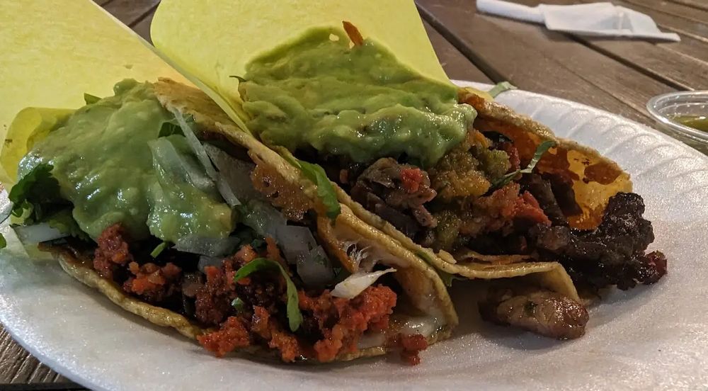 two delicious looking and completely stacked street tacos from tire shop taqueria #2 , located but steps away from the shitty tesla slop shop