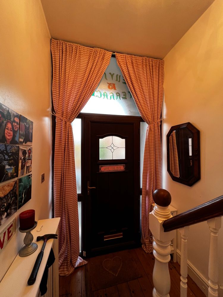 My hallway, featuring new hand made fleece curtains. There are glass panels all around the door and it gets very cold. Fingers crossed that the curtains will help a bit. 