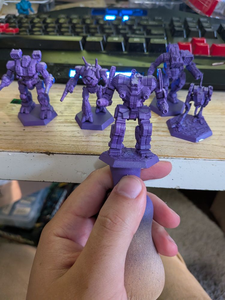 Five Battlemech models primed in Alien Purple. From right to left: Warhammer, Wraith, Awesome, Orion, and Locust. The Awesome and Locust are Iron Wind Metal miniatures while the rest are CGL plastic.