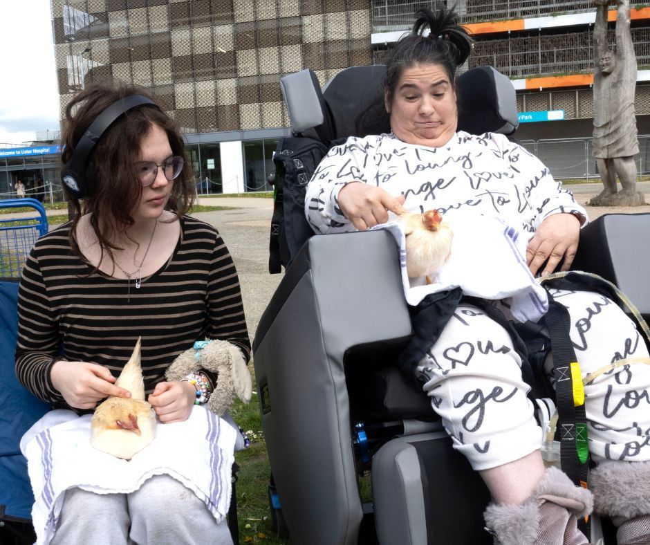 Two patients visiting the hospital, each holding a chicken