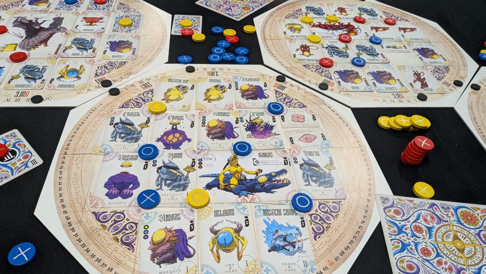 Personal Demons board. An octagonal board is filled with cards. The cards represent demons and you form seals on the corners of the cards. 