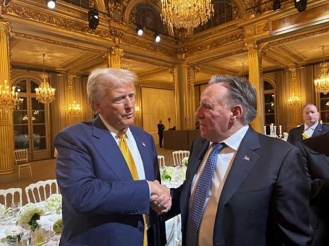US President elect Donald Trump shaking hands with Quebec Premier François Legault in an opulent, chandelier-lit banquet hall