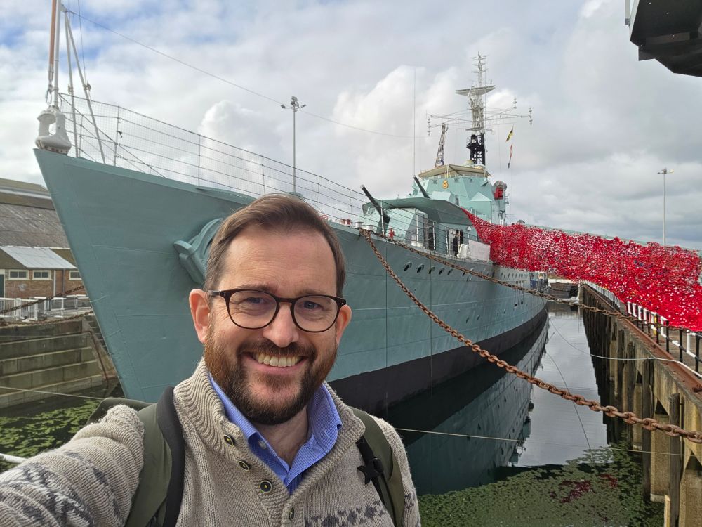 The author looks happy in front of HMS Cavalier