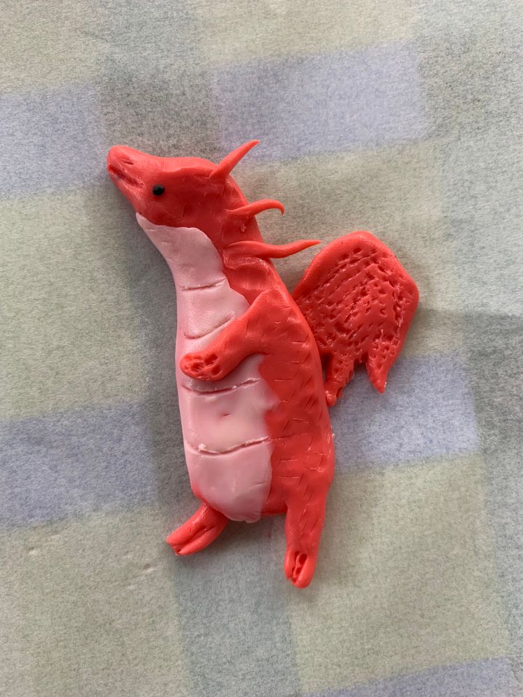 A little polymer clay magnet of Spark the Dragon