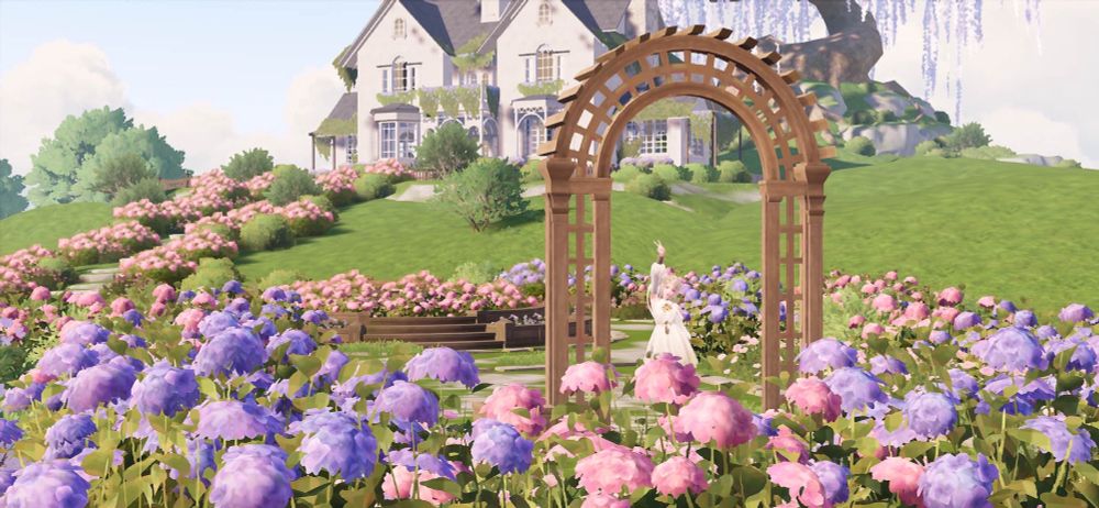 Pic of the new house in Infinity Nikki that is a mansion with cream walls and stone grey roof, surrounded by gorgeous lavender and pink hydrangea bushes. Nikki is standing under a little wooden arch giving a peace sign to the camera 
