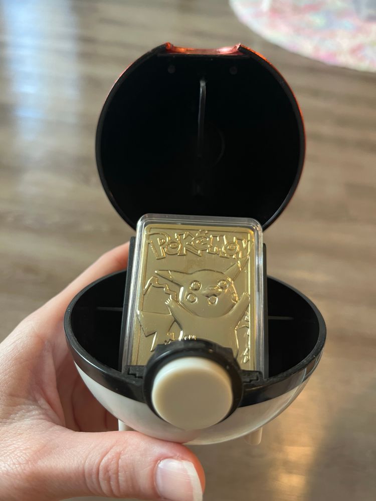 A gold-plated pikachu card in a Pokeball that opens very much like a ring box