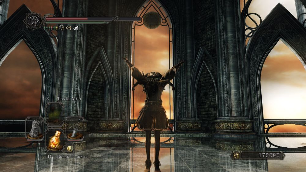 A screenshot of Dark Souls 2 showing a character in the Jester's set performing the Praise the Sun gesture in Sir Alonne's boss arena