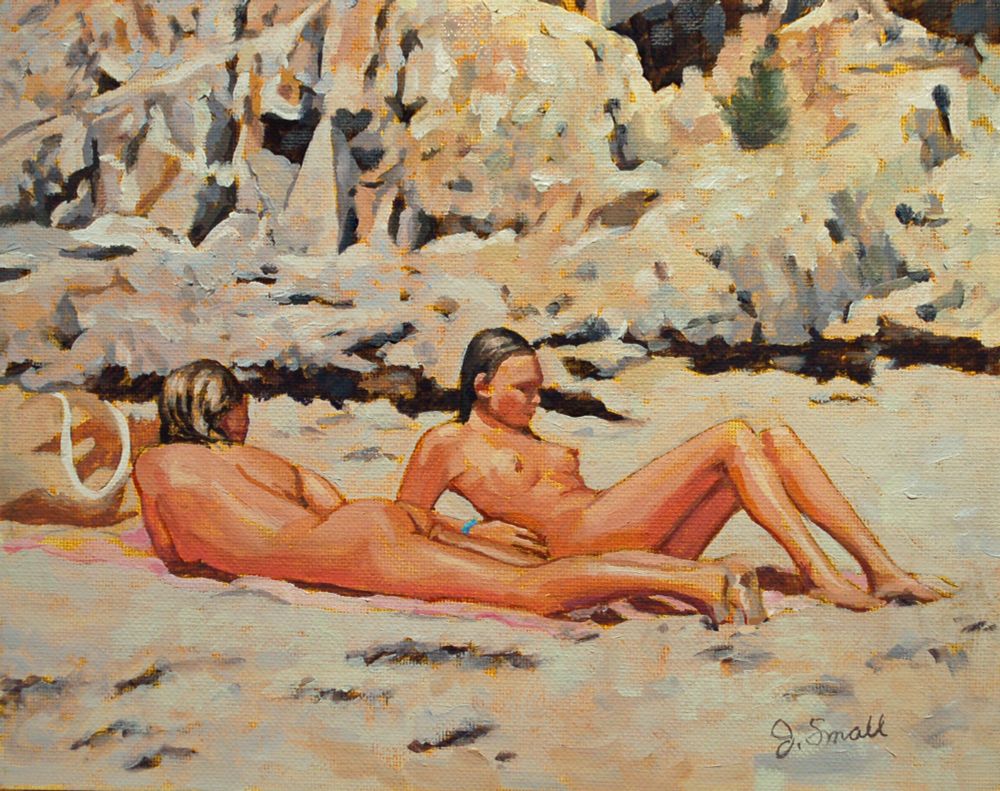 A painting of two nude female figures lying on a sandy beach. One is on her stomach and one is sitting up slightly with her upper body propped up on her elbows. The background is rocky.