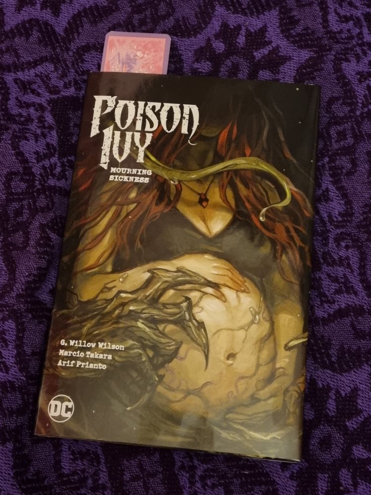 The cover of Poison Ivy Volume 3: 'Mourning Sickness' written by G. Willow Wilson and art by Jessica Fong. The cover features Pam AKA Ivy with a monstrous looking pregnant belly covered with green veins and/or vines