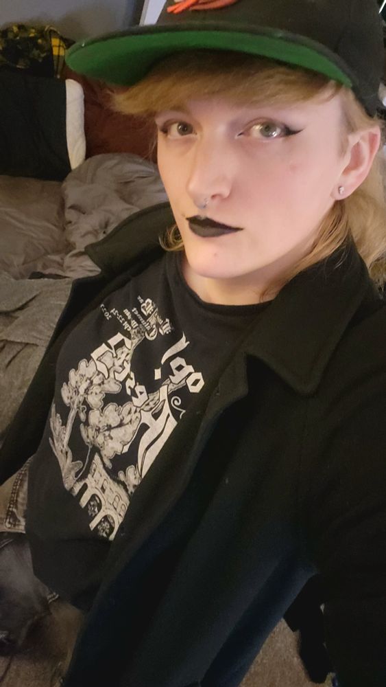 Caiti shown from above with her eyeliner and black lipstick