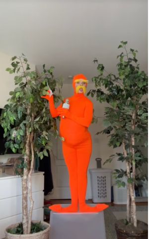 @ashby on tiktok dressed up like the lorax.  here, she looks like an orange IUD