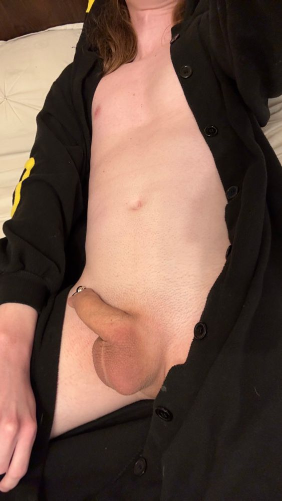 Me on my bed wearing an Umbreon kigurumi and showing the goods