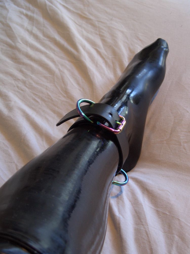 multiple angles of an image of a latex sock, with a bdsm ankle cuff made of biothane 