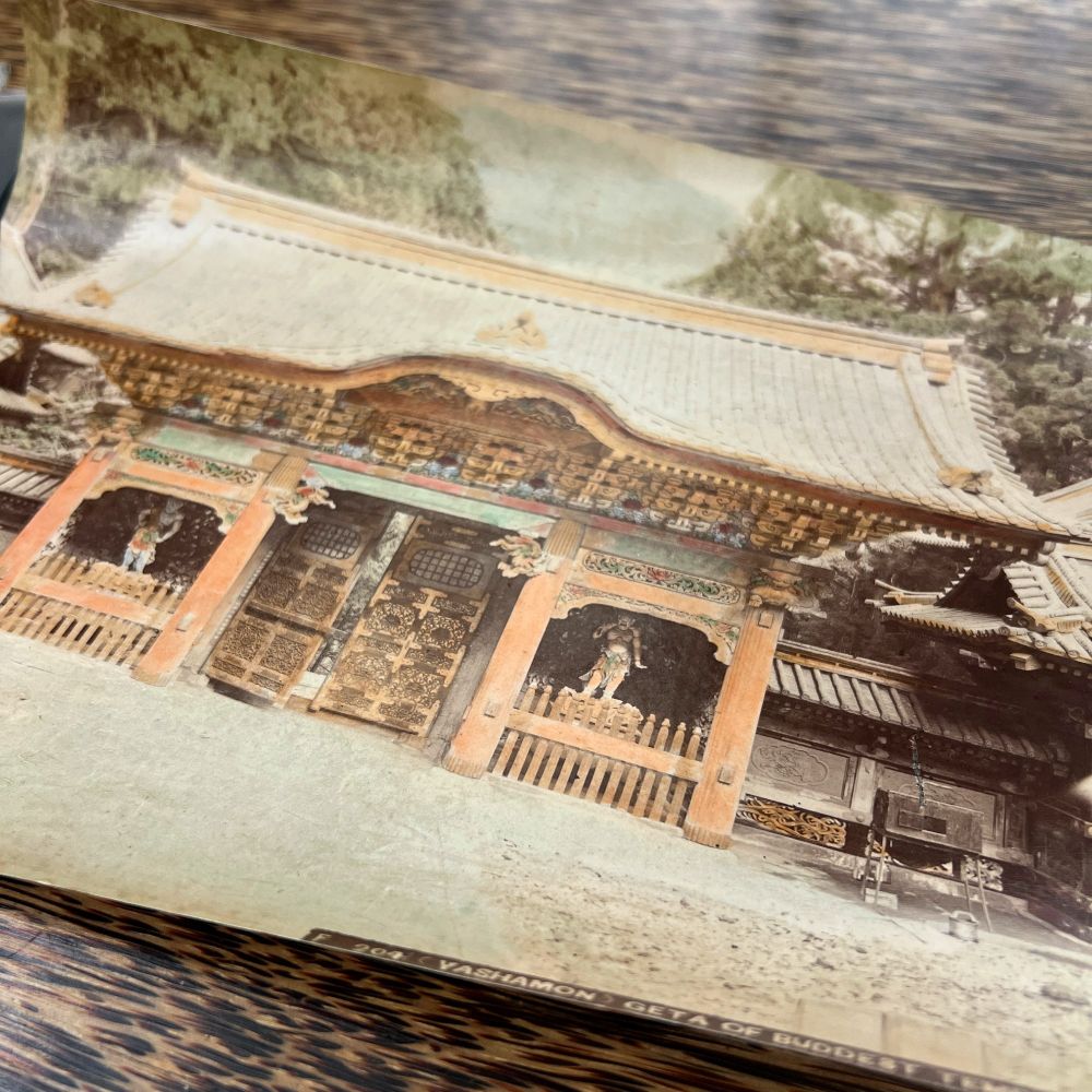Image shows the photograph, curling at its edges, on top of a wooden table.