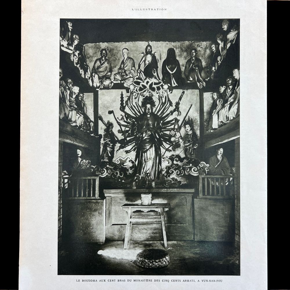 The image shows a black and white photograph of a Guanyin statue with multiple arms, centrally placed within a room. The statue is elaborate, with several radiating arms each holding different objects. It stands on a pedestal in front of an intricate backdrop that appears to include swirling cloud-like patterns. Surrounding the central figure are smaller statues or carvings located on two tiers of platforms resembling a theater or gallery setting. The upper tier seems to contain seated figures in rows, while the lower level hosts standing figures clothed in traditional attire. The room appears to be part of a temple or monastery, characterized by wood and stone structures.

Sort available posts on Bluesky using #Buddhasinthewest | All posts archived here: tinyurl.com/4kmcwp87 🔍 🗃️ 📜