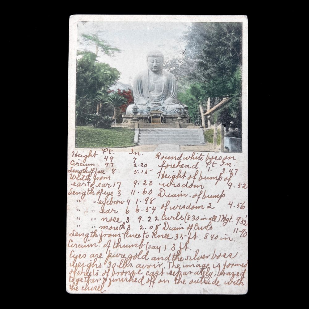 Image shows early 20th century postcard with top half bearing a hand-colored collotype print of the Kamakura Daibutsu. The print show the entire Buddhist icon and part of its outdoor setting. The lower half of the postcard bears a hand-written message, as was typical for cards prior to 1907. 