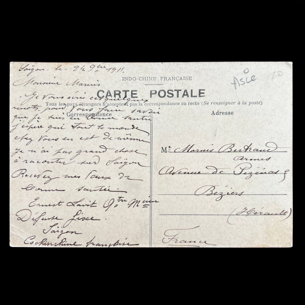 Image shows the reverse with a divided back for address and message. There is a message written in French. Dated 1911, the postcard was sent from Saigon to Béziers, France. 