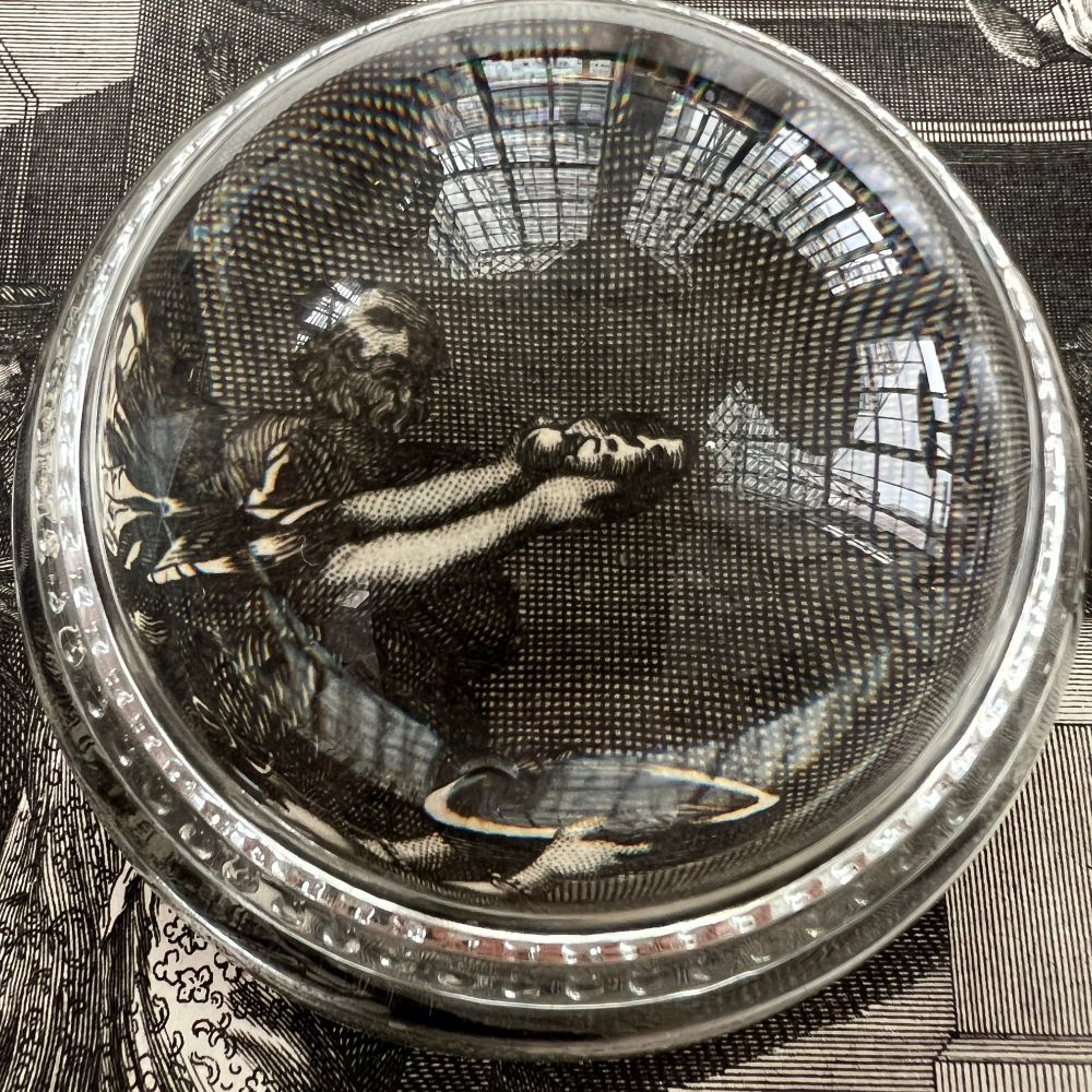 Image shows a magnifying globe highlighting offerings being presented to the icon.