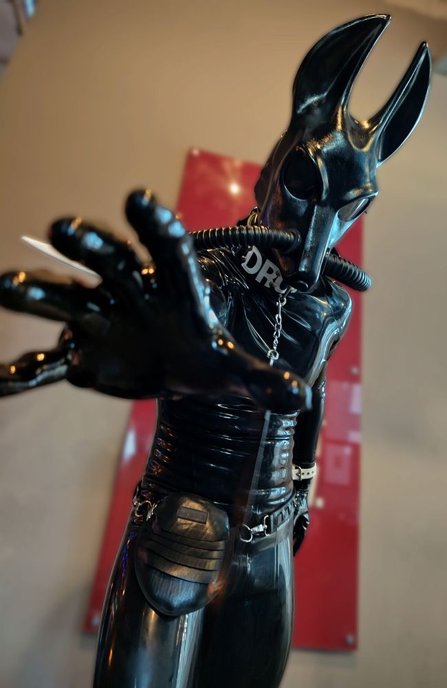 The Jackal Drone reaching down towards the camera, its hand open about to grab the viewer.