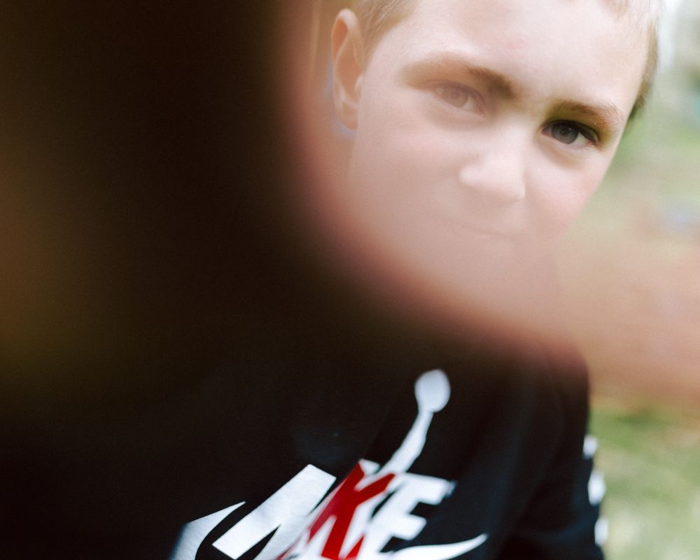 A photo of a boy staring at the camera.