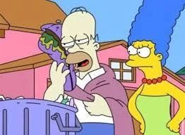 Homer Simpson hugging a rotten sandwich while Marge Simpson looks at him angrily 