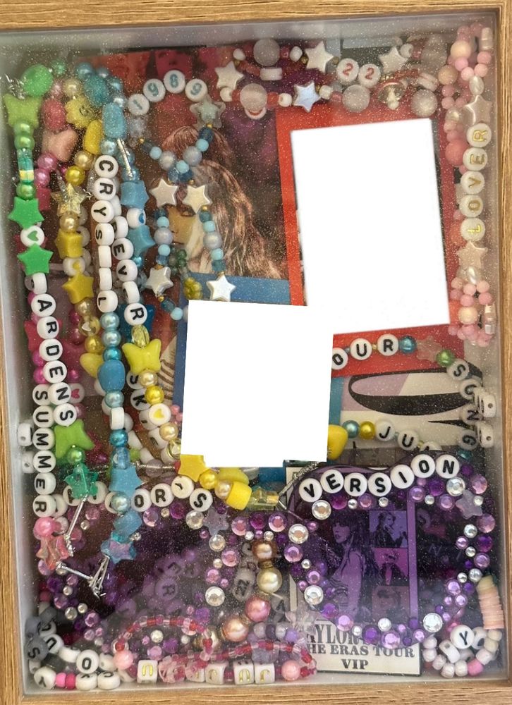 an eras tour memory box consisting of a brown frame with friendship bracelets and eras tour sunglasses inside.