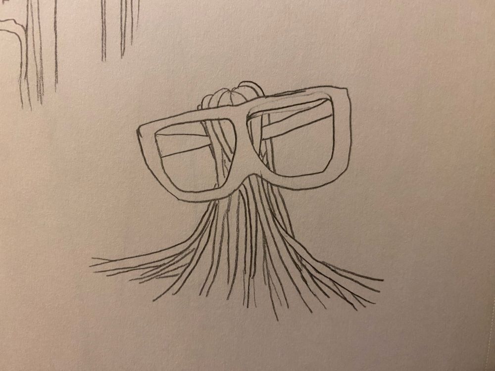 An abstract armless leafless figure made of ropes with gigantic oversized glasses.