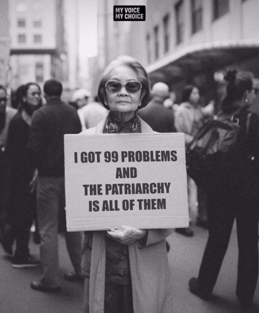 Photo of woman holding a sign that says I got 99 problems and the patriarchy is all of them.