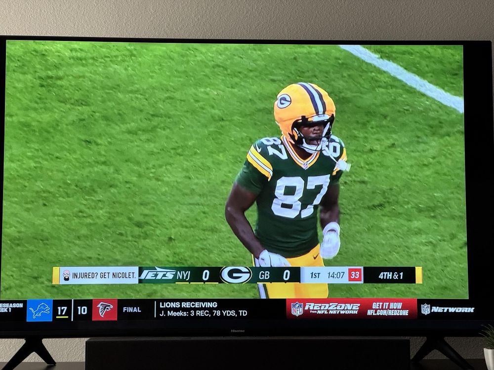 a Green Bay Packers player with a helmet with large padding around it