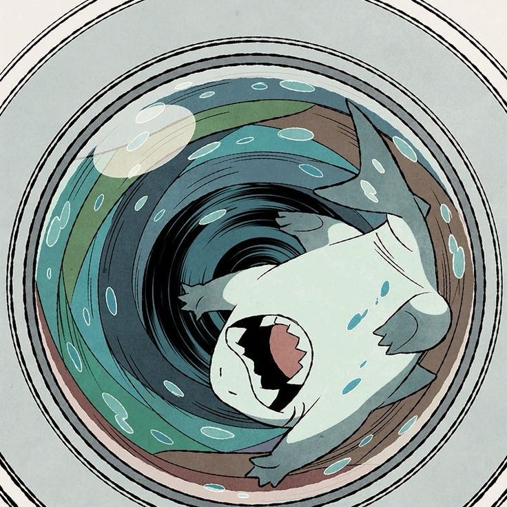 Jeff the Land Shark with happy grin in washer with clothes on a spin cycle