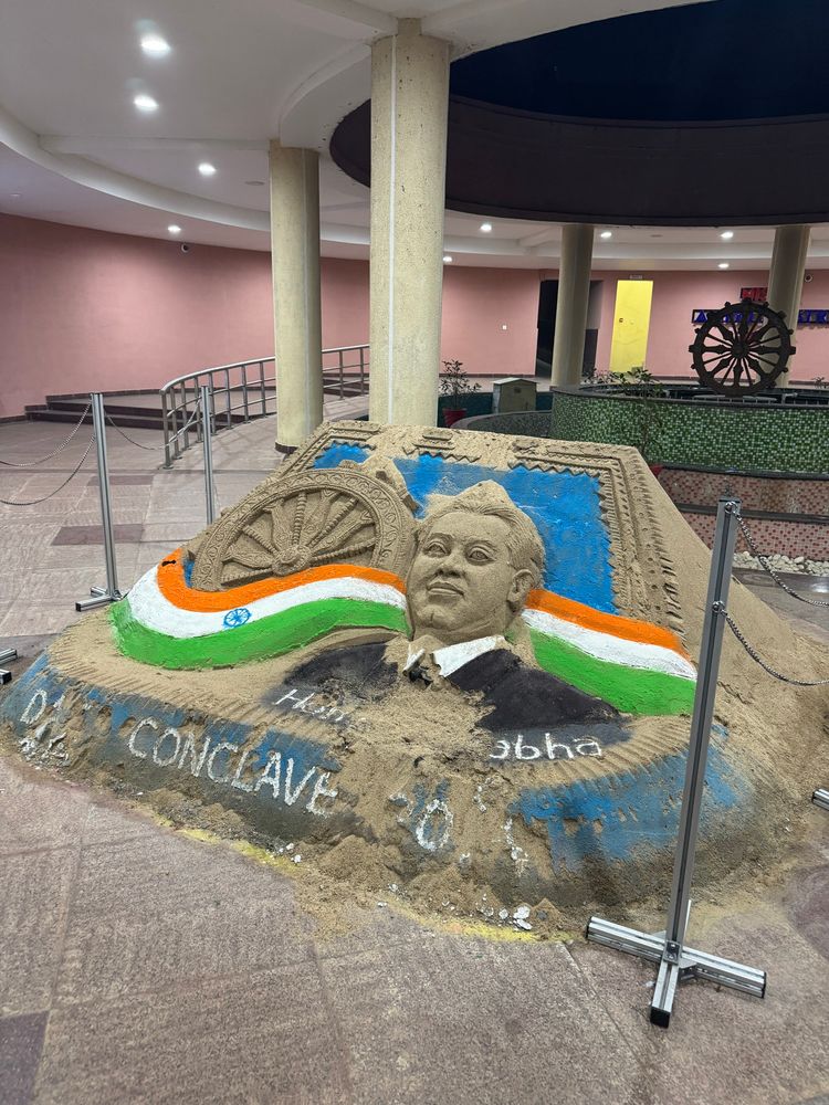 Sand sculpture of Homi Bhabha with “DAE CONCLAVE” written.