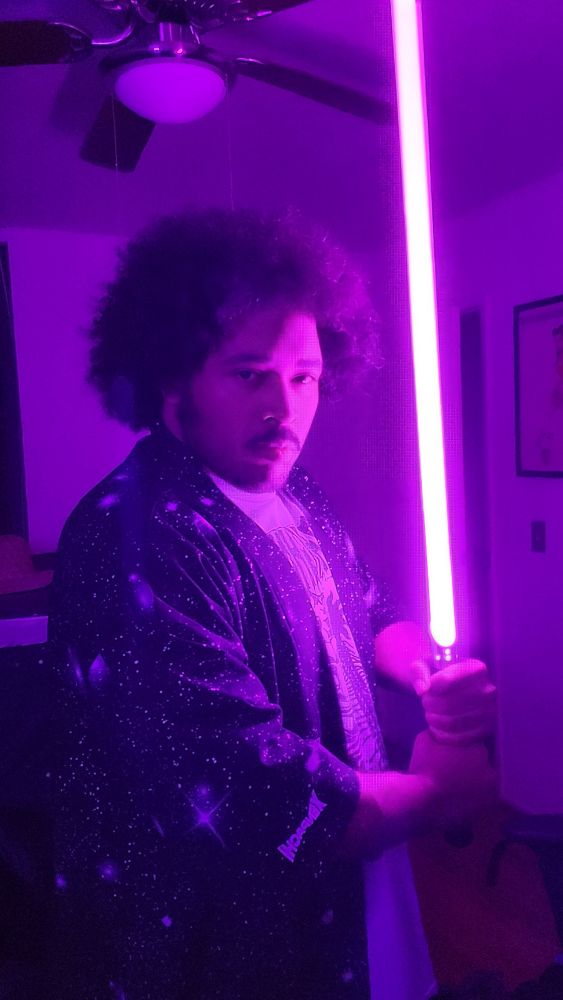 Posing with light purple light saber in space kimono.