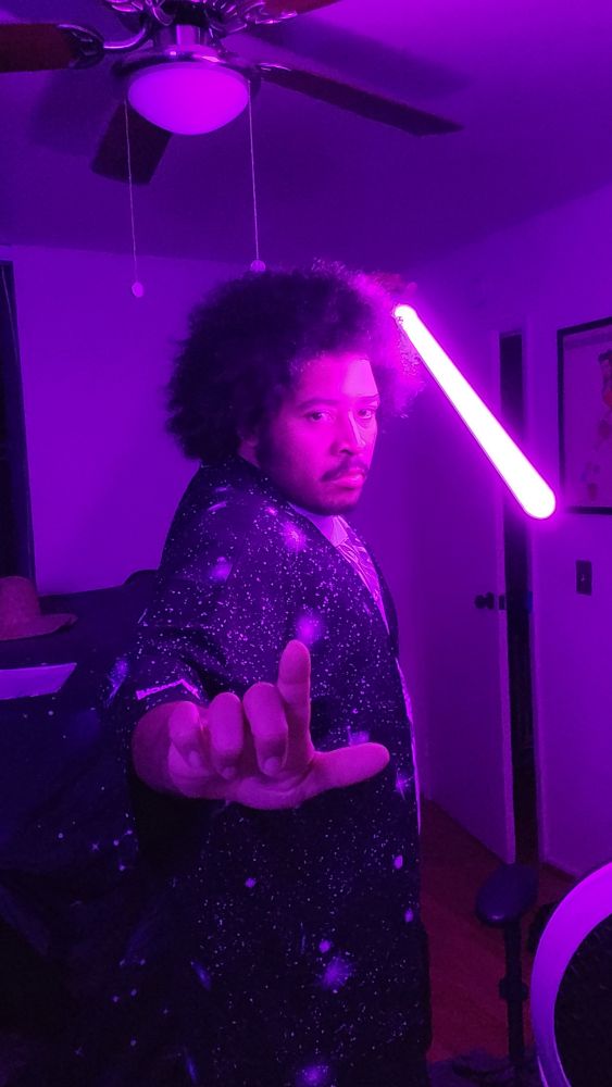 Posing in different stance with purple light saber in space kimono. 