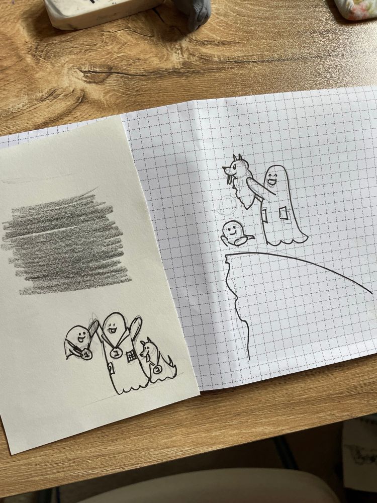 sketches of ghosts. one depicts the ghosts wearing medals and raising their arms in victory.
a second shows the tall ghost
raising the ghost dog in a parody of The Lion King while the smaller ghost
smiles. There are pencil scribbles from transferring a previous sketch. 
