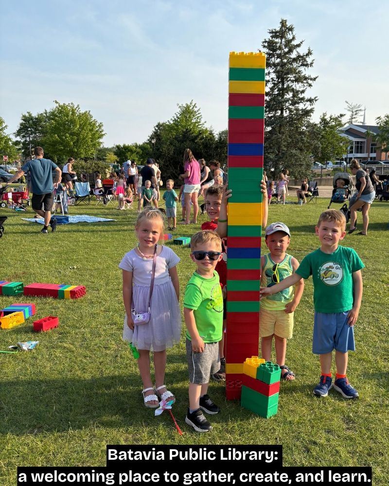 Photo of five children who built a tower using jumbo LEGO bricks during the Family Concert with Justin Roberts on Wed., June 11, 2025.