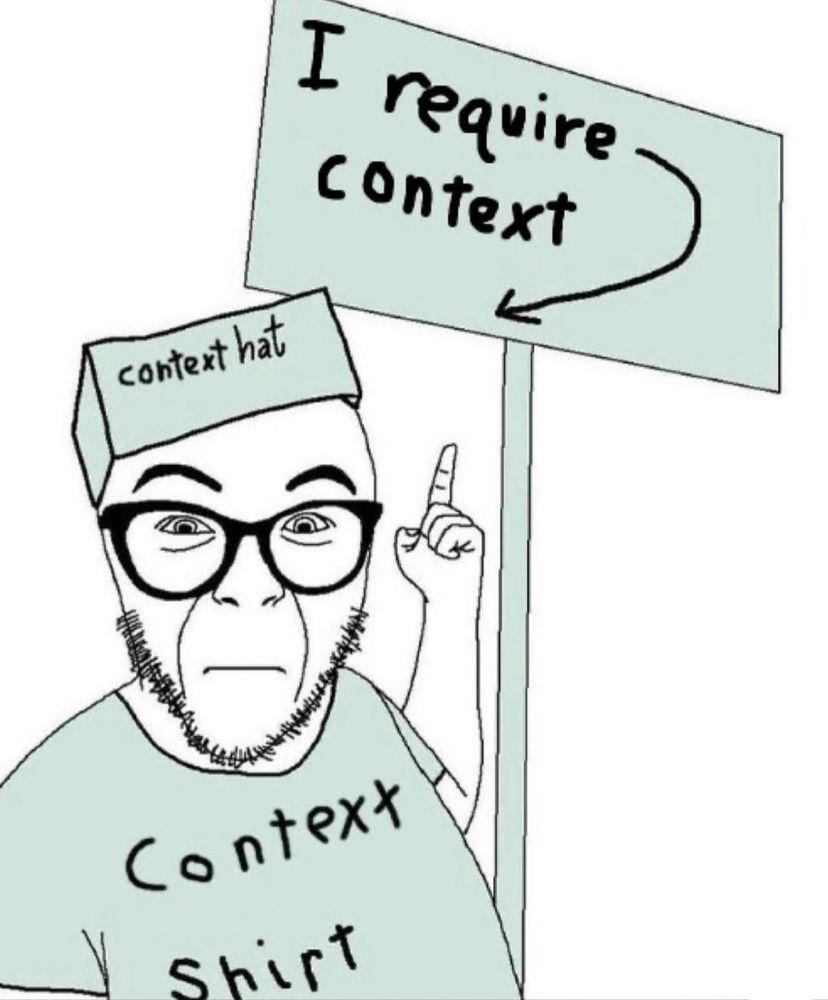 I require context wojack wearing a context hat and context shirt holding a sign that says "I require context". The sign has an arrow that points at the aforementioned wojack. The wojack (me) requires context (context)