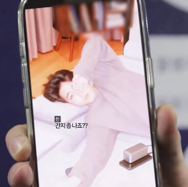 same thing except zoomed in to see the pic better. he looks like hes rubbing his eye and hes sprawled out, hair falling all over the place. he just looks very cute and well loved