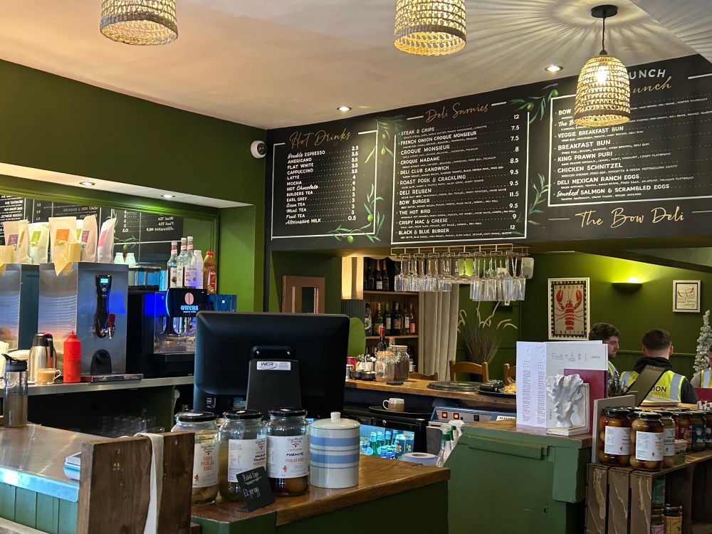 Deli with boards full of fancy sandwiches.