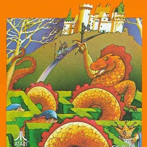 The box art for Atari Adventure is orange, and it features a highly detailed painting of a sword and sorcery scenario. At the top is an elaborate castle with towers and roofs and parapets. A road leads downward from the castle to an elaborate hedge maz, and two heroes in pointed caps with walking sticks walk down the road towards the maze. A giant orange dragon sits inside the maze holding a key aloft in its bony talons. The dragon’s snake-like body coils through the maze and wraps around a tree. Several other heroes in pointed caps are lost in the maze, and we can only see their heads. A gleaming bejewelled crown or chalice is visible in the foreground.