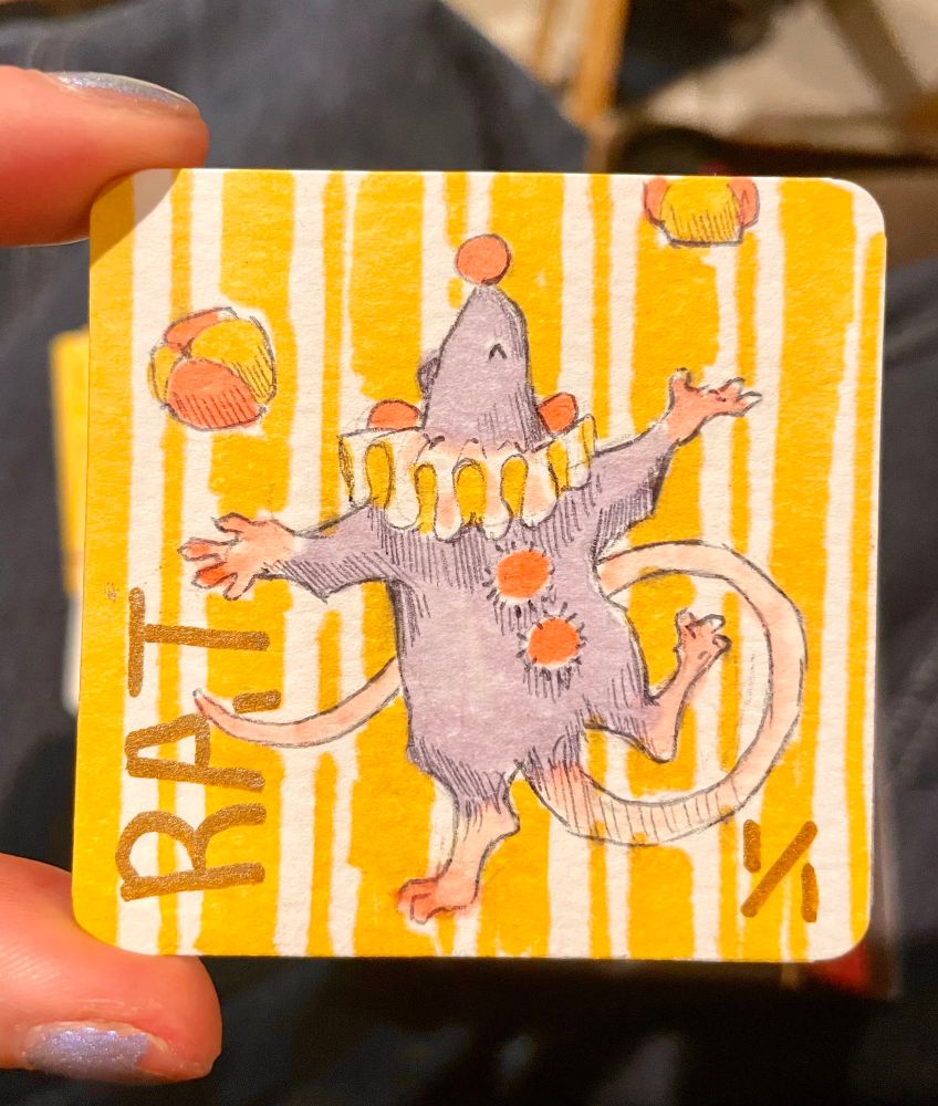 This lil circus rat is juggling! He’s standing on one leg and looks like he might tip over.