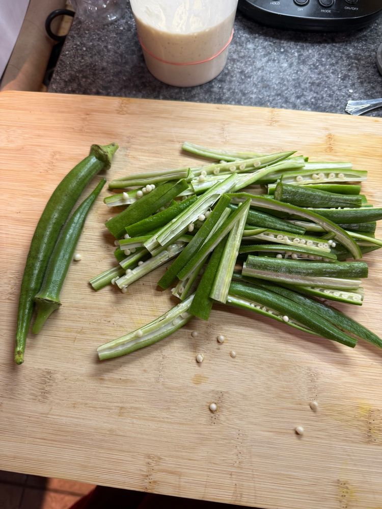 Just a bunch of fresh-picked okra from my garden, cut into okra fries on a bamboo cutting board.