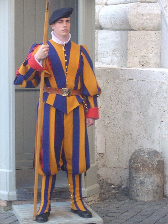 Picture of an officer of the Papal Swiss Guard, wearing the traditional yellow and gold uniform