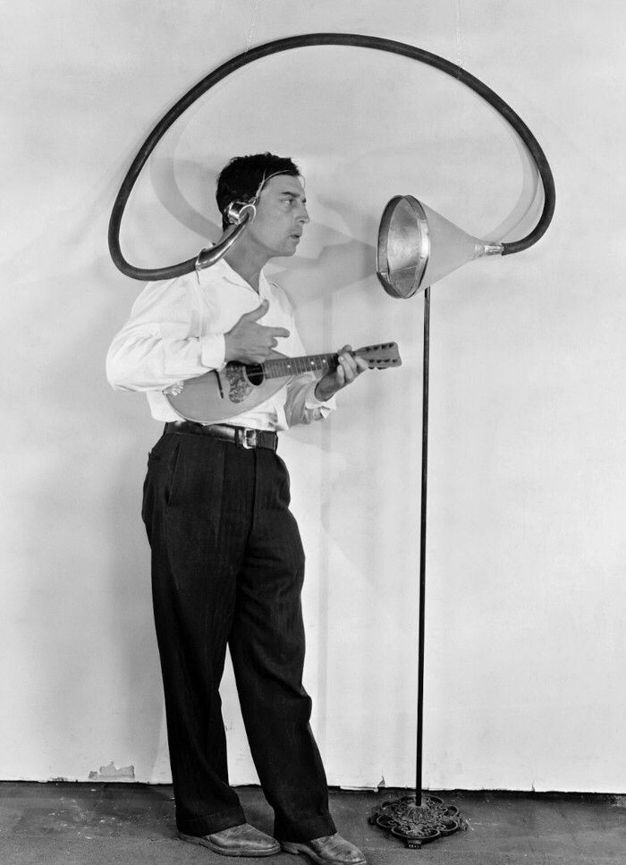 Buster Keaton plays a ukulele into a strange audio feedback contraption circa 1929.