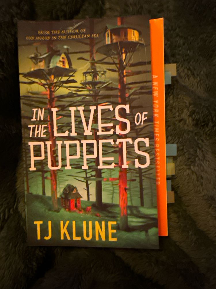 Cover image of “In the Lives of Puppets” by TJ Klune with several page tabs. 