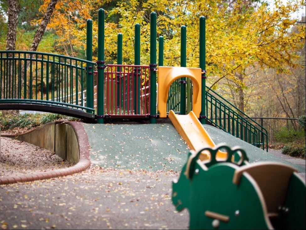 kids playground with a yellow slide
